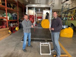 SSPOA FireSmart Committee Member Warner Grunewald receiving a tour of Coldstream Fire Department’s Sprinkler Protection System from fire fighter Nathan Betz